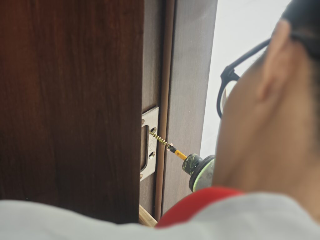 Bắt vít bản lề vào khung bao